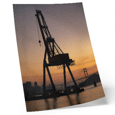 Impression sur toile Silhouette de grue industrielle au coucher du soleil sur le pont