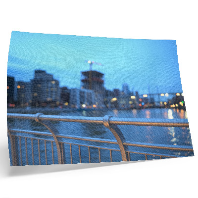 Affiche Le front de mer de la ville le soir, avec des lumières floues