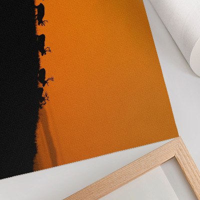 Affiche et poster Silhouettes de cerfs sur une colline avec un fond orange