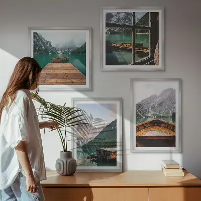 Mur de tableaux représentant des paysages de montagne avec des chalets et des bateaux