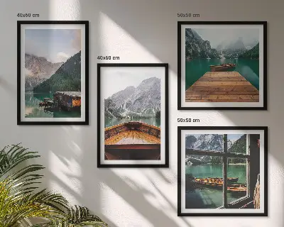 Mur de tableaux représentant des paysages de montagne avec des chalets et des bateaux